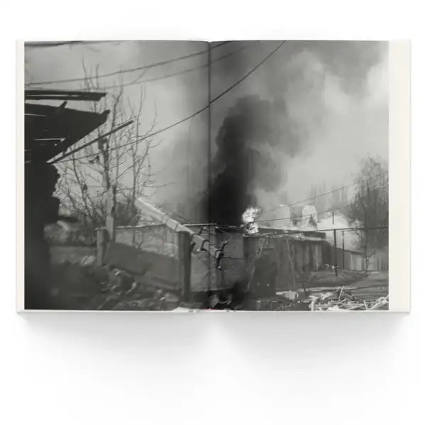 Black and white photograph of a building on fire with smoke from Bakhmut by Myroslav Laiuk war reportage books Black and white photograph of a building on fire with smoke from Bakhmut by Myroslav Laiuk war reportage books