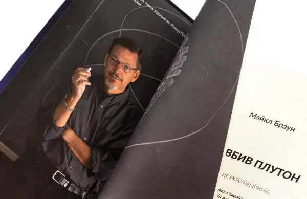 Book titled How I Killed Pluto and Why It Had It Coming featuring a man in glasses Book titled How I Killed Pluto and Why It Had It Coming featuring a man in glasses
