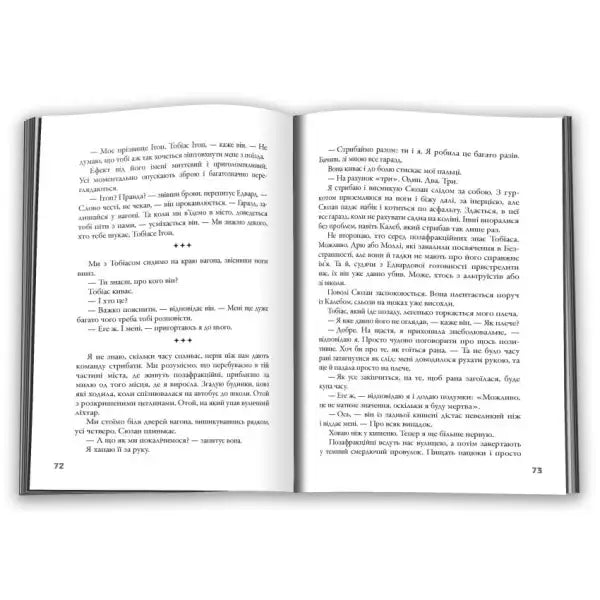 Open book with printed text from Insurgent by Veronica Roth, dystopian YA sequel featuring faction war Open book with printed text from Insurgent by Veronica Roth, dystopian YA sequel featuring faction war