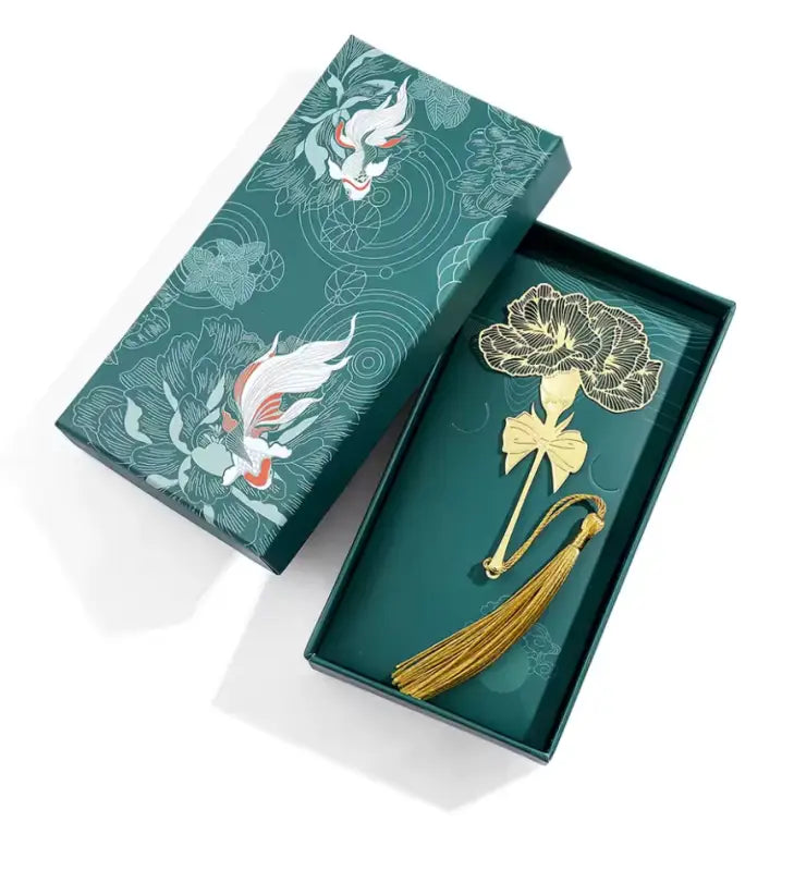 Green gift box with a floral bookmark featuring a brass flower tassel tassel bookmark Green gift box with a floral bookmark featuring a brass flower tassel tassel bookmark