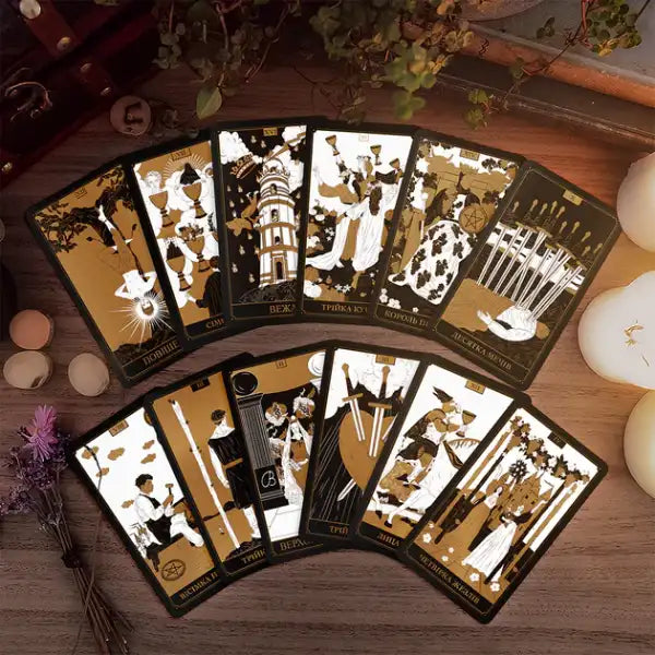 Arrangement of black and gold tarot cards from The Golden Deck featuring upright and reversed meanings Arrangement of black and gold tarot cards from The Golden Deck featuring upright and reversed meanings