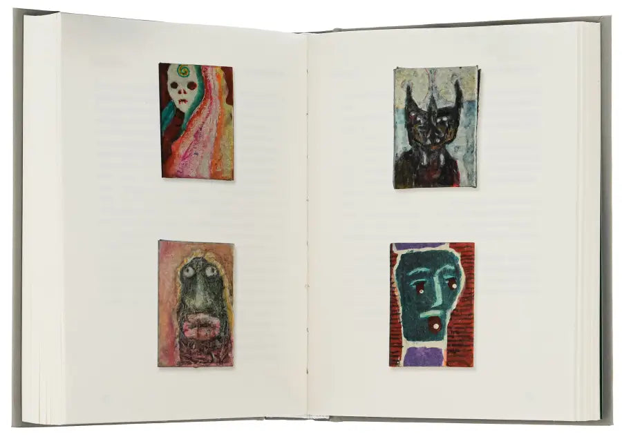Open sketchbook with four small paintings.