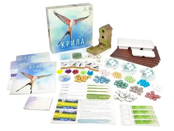 Wingspan board game box with bird in flight and components Wingspan board game box with bird in flight and components