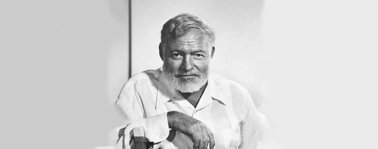 Portrait of Ernest Hemingway featuring his book collection and books for Courage is grace under pressure
