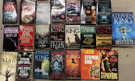 A collection of Stephen King novels arranged in five rows on a flat surface. Titles include "The Stand," "Carrie," "The Green Mile," "The Talisman," "Dreamcatcher," "The Institute," 
