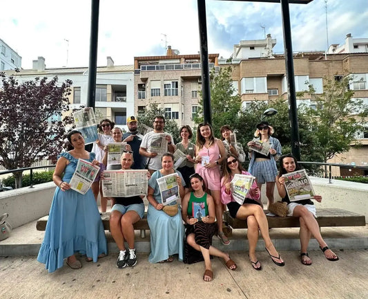 Group of people holding newspapers at Ukrainian Book Club in Valencia discussing kill consciously