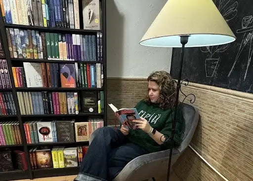Woman reading English books about Harry Potter in a chair for love of books