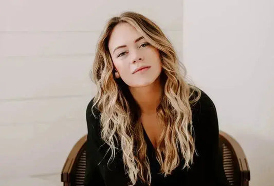 Woman with wavy blonde hair representing the inspiring cover of Brianna Wiest’s books