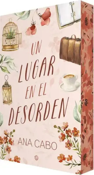 Soft pink Ana Cabo Spanish romance book cover with watercolor birdcage, suitcase, lantern, coffee cup, and florals from A place in the disorder