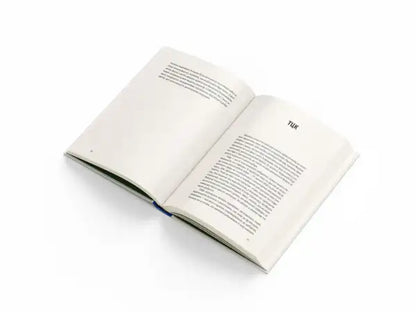Open book with white pages and blue spine from Ukrainian edition of All In Three Letters by Dmytro Krapyvenko