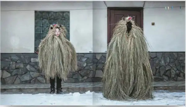 Two people in traditional straw costumes for Ukrainian winter Malanka by Bohdan Logvinenko