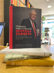Hardcover book with Warren Buffett portrait highlighting best books on financial literacy