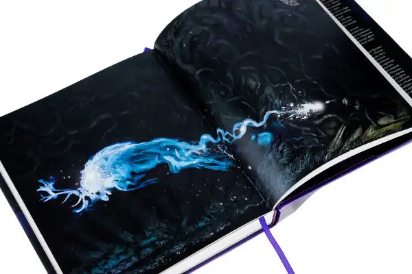 Open Harry Potter and the Prisoner of Azkaban Illustrated Edition with glowing blue stag by Jim Kay