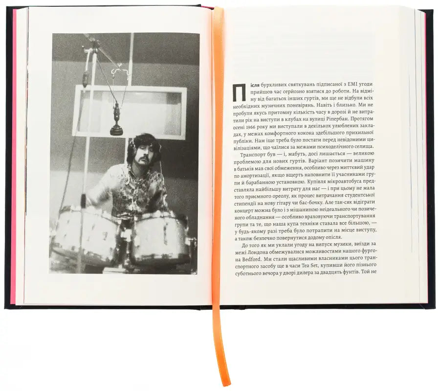 Open book with a black and white photo of a drummer.