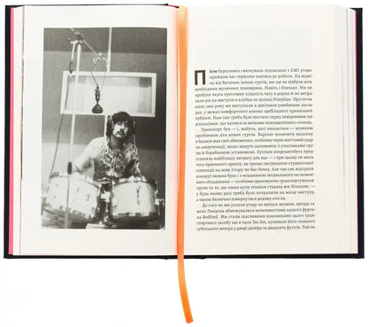 Open book with a black and white photo of a drummer.