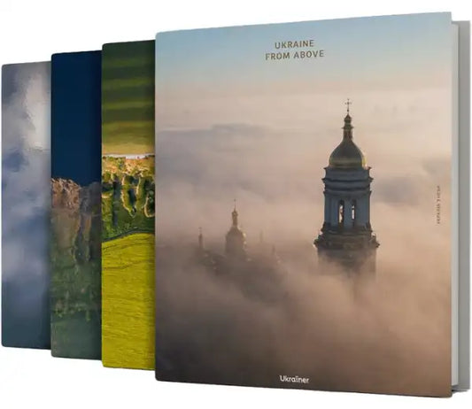 Stack of books with a golden-domed church tower from Ukraine from Above by Bohdan Logvinenko Ukrainian Edition large-format photo book